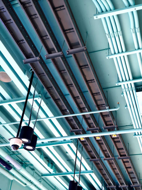 istock Ceiling with ventilation pipes and lights in industrial building 2161010864