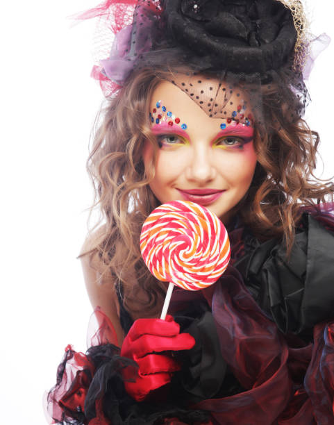 istock Girl with with creative make-up holds lollipop. 2161015199