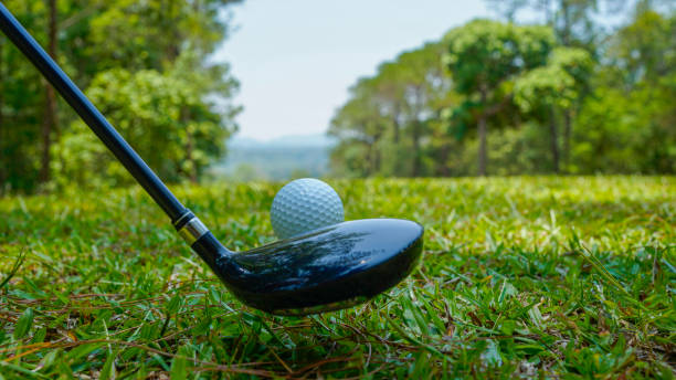 istock Golf balls on the golf course with golf clubs ready for golf in the first short. 2161015835