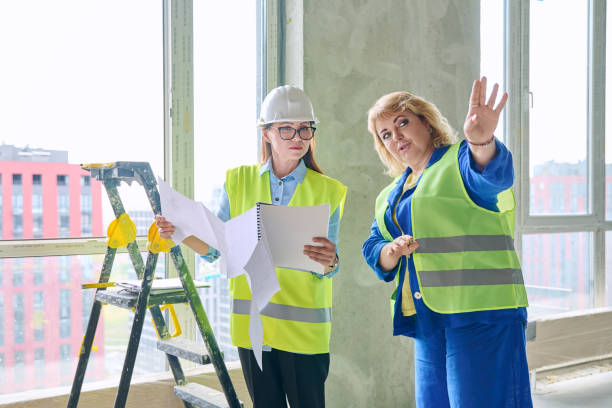 istock Two female industrial workers at construction site discussing work plans 2161018959