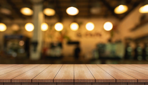 istock Empty wooden table top with lights bokeh on blur restaurant background. 2161020425