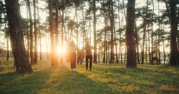 istock Heartwarming Family Walk Through Forest at Sunset, Slow Motion 2161020955