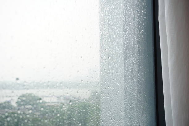 istock Window with white voile curtain reflection during the rain 2161022395