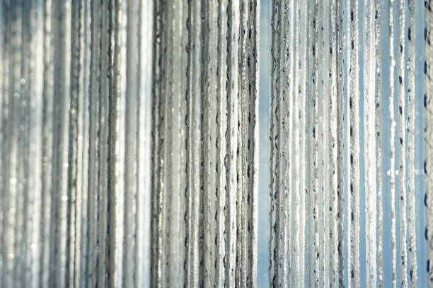 Vibrant strands of shimmering beads hang elegantly, creating a colorful decorative backdrop for events and celebrations.