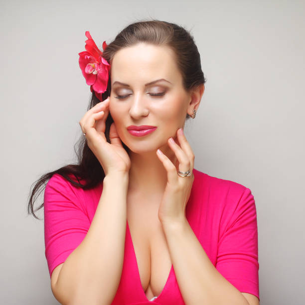 Close-Up Of Beautiful Woman Holding Pink Flower