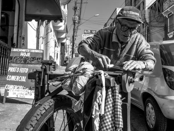 Sao Paulo, Brazil, June 09, 2006: old man works as a walking grinder of knives and scissors on the streets of the city of Sao Paulo