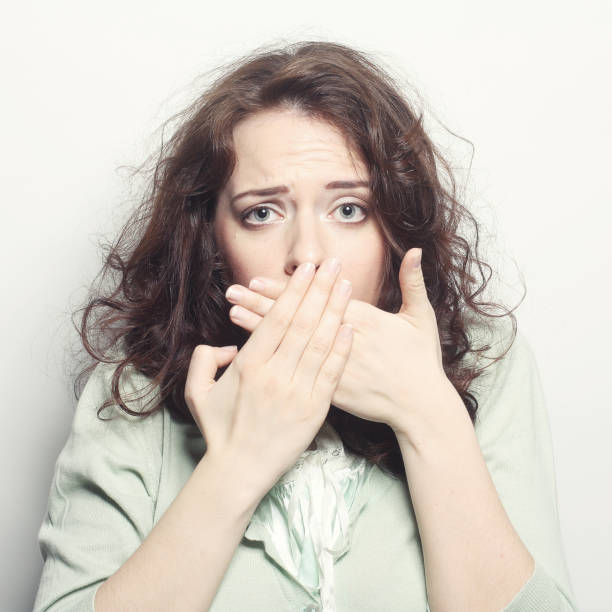 istock young woman covering the face with her hand 2161024003