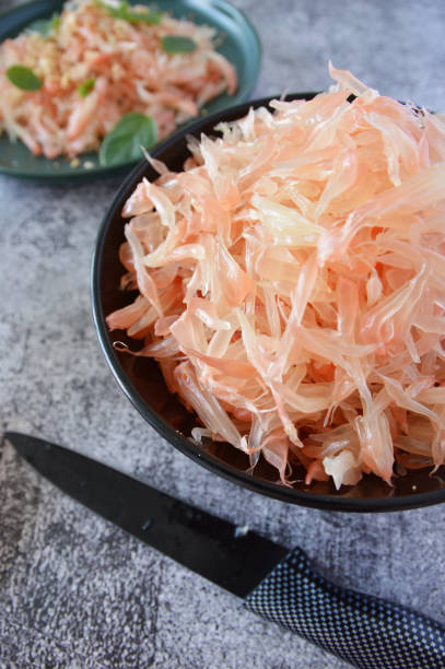 istock A bowl filled with pink pomelo vesicles in a rusty background 2161024181