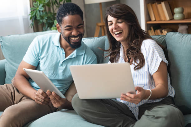 istock Young happy business people using digital tablet surfing the net searching for appropriate campervan for vacation travel. Business owners sold their work for adventure and camping. Freedom concept 2161026357