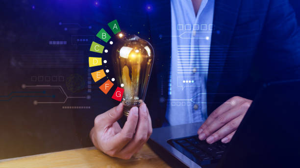 istock Energy efficiency concept, House energy efficiency or energy saving rate for reduce carbon footprint, hold light bulb with energy efficient rating class concept save cost green energy. 2161027522