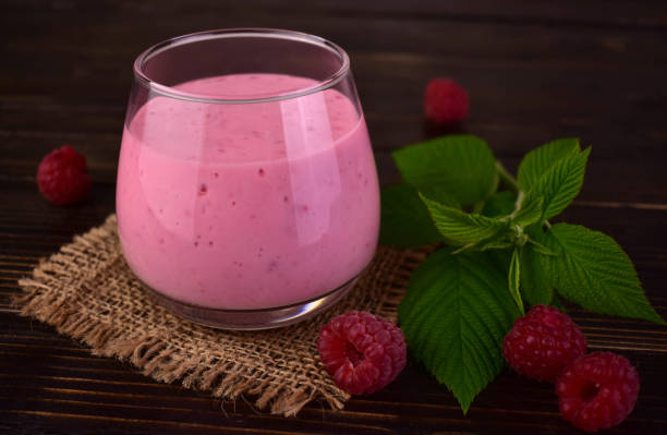 istock Raspberry smoothie in a glass on a dark wooden background. 2161033480