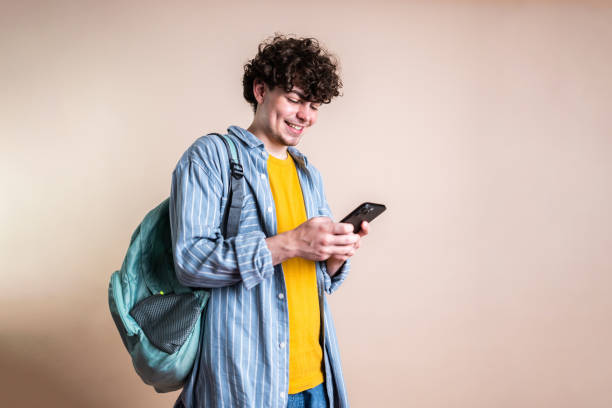 istock Young transgender male student using smartphone on a studio shot 2161034891