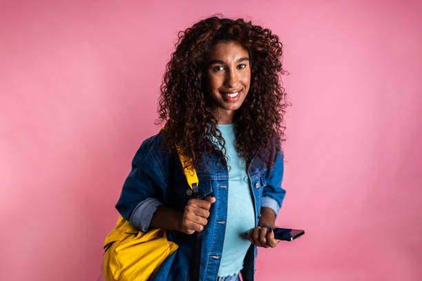 istock Portrait of a young transgender female student using smartphone on a studio shot 2161035165