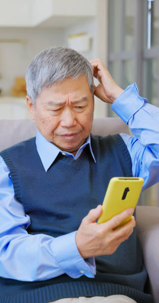 istock asian old male smartphone scammed 2161036719
