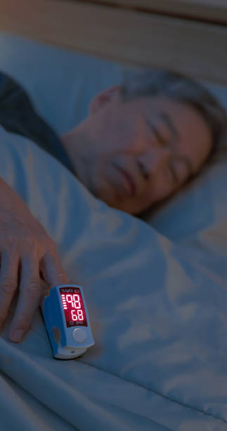 istock man sleep with pulse oximeter 2161037423