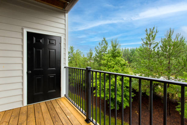 istock Balcony With Black Door, Surrounded By Green Trees And A Clear Blue Sky. 2161041093