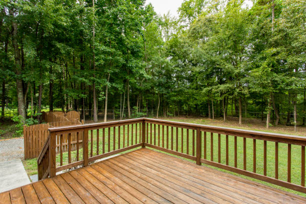 istock Wooden Deck Overlooking A Vast, Open Green Lawn With Surrounding Trees. 2161041252