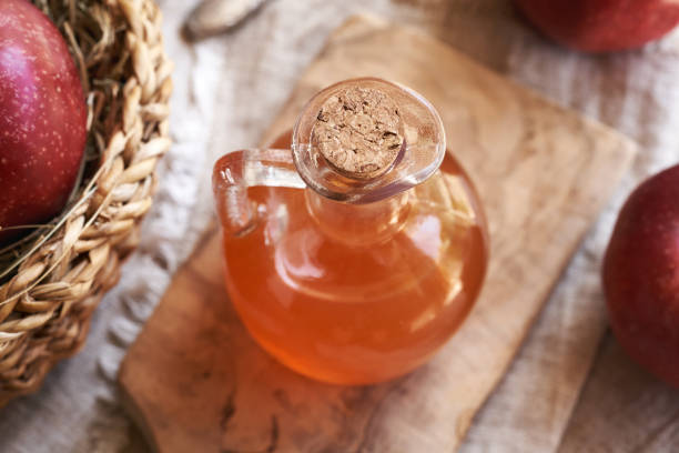 istock Apple cider vinegar in a glass jug with ripe red apples 2161042655