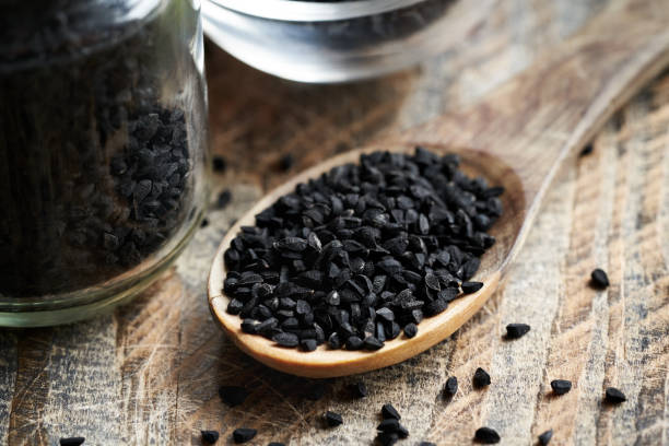 istock Black cumin or Nigella sativa seeds on a spoon. Nutritional supplement. 2161042868