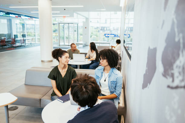 istock University students in classroom developing new scientific project. Students talking to female African professor during or after the lectures 2161046352
