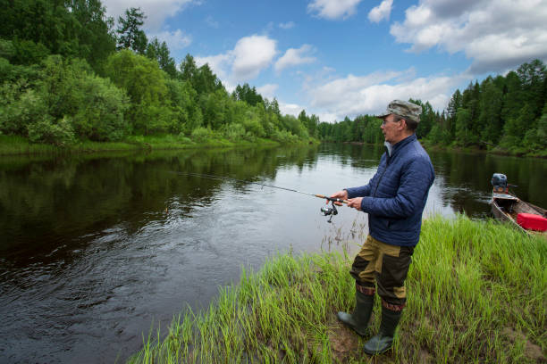istock A man with a spinning is fishing on the river. 2161047337
