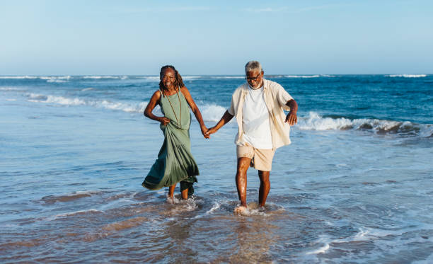 istock Joyful senior couple walking by the sea 2161049821
