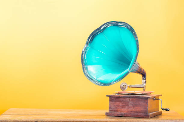 istock Vintage antique gramophone phonograph turntable with mint blue horn on oak table front yellow background. Retro style filtered photo 2161050031