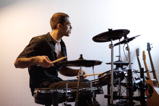 istock Focused mixed race drummer playing drums in music studio 2161050979
