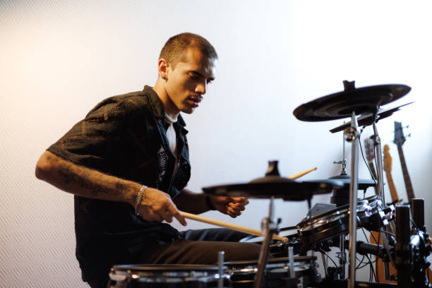 istock Young mixed race drummer playing drums in music studio 2161051010