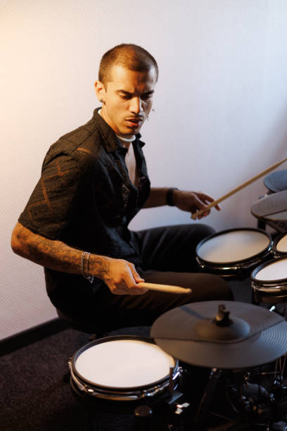 istock Stylish multiracial musician playing drums in music studio 2161051047