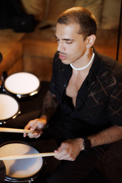 istock Young multiracial man playing drums in music studio 2161051132