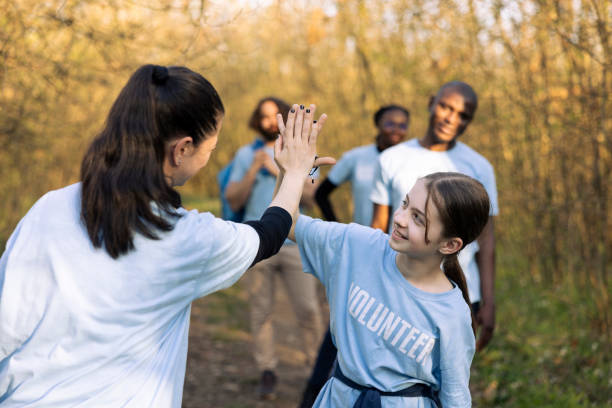 Cheerful woman doing high five with her daughter after finishing activity