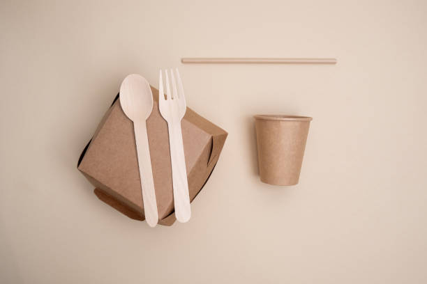 istock Kraft paper tableware: cups, food boxes, isolated on a light background. A set of various disposable tableware. Recycling and zero waste concept. Mock up 2161055044