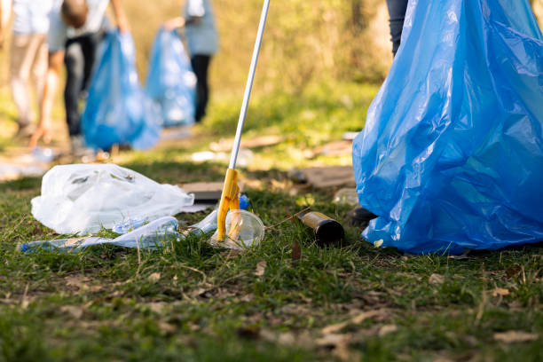 istock Activist using claw tool to collect rubbish and plastic junk from the ground 2161055583