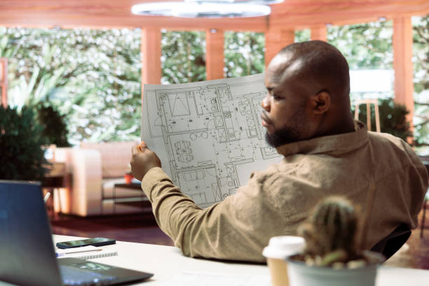 istock Small business owner analyzing architectural sketches and planning office spaces 2161055939