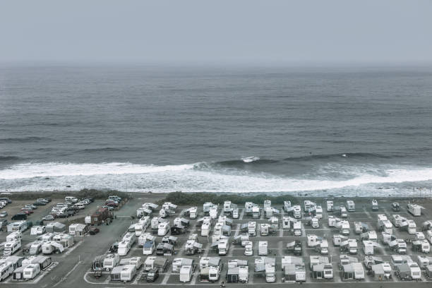 Group of RVs are parked on a beach in Gran Canaria. Overhead shot of numerous RV's parked in a lot