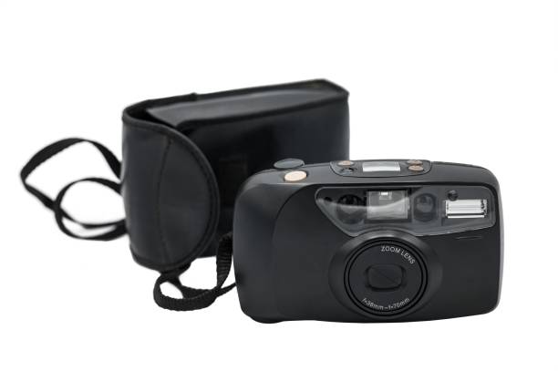 istock old compact camera with its black case on a white background. It is the typical compact zoom camera 2161058243