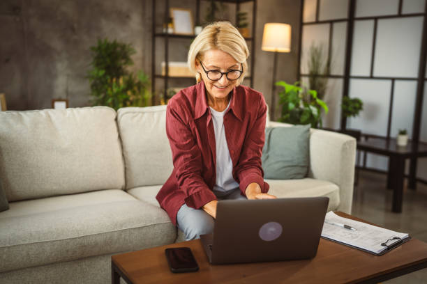 istock Mature senior woman work from home on laptop 2161058867