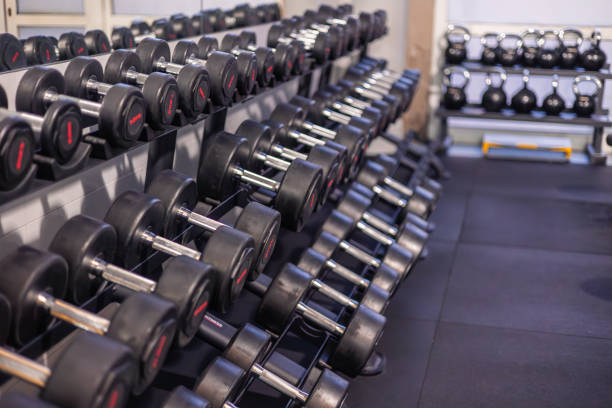 istock Various Weight Dumbbells Organized on Gym Rack Ready for Strength Training 2161059247