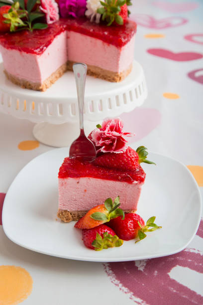 istock Strawberry and passion fruit cheesecake decorated with fruit and flowers over a hearted background 2161059286