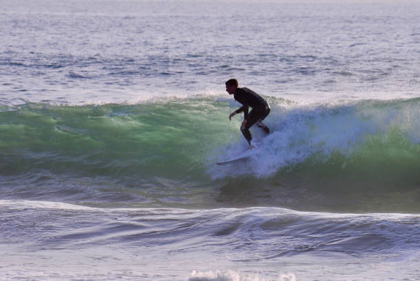 istock Surfer Dropping in on a Green Wave 2161062692
