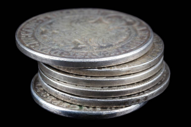 Stack of old vintage silver medieval taller coins on black background