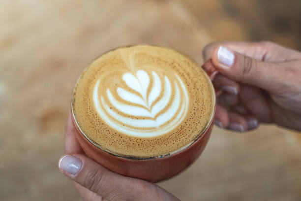 istock woman holds latte coffee in hand 2161073560
