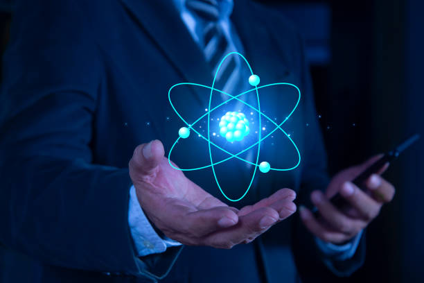 istock Bussinessman hand holding creative atom on blue background. Nuclear fusion concept, endless energy, cheap electricity, future technologies. Science and future concept 2161073563