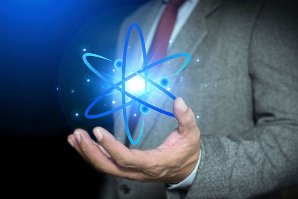 istock Bussinessman hand holding creative atom. Nuclear fusion concept, endless energy, cheap electricity, future technologies. Science and future concept 2161073611