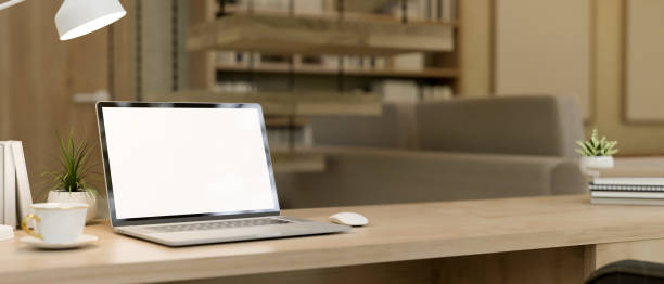 A laptop computer with a white screen mockup on a desk in a modern living room or private office. place of work concept. 3d render, 3d illustration
