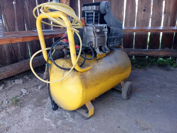 istock A yellow compressor stands in a gazebo in the yard. Electric tool for creating pressure. 2161080940