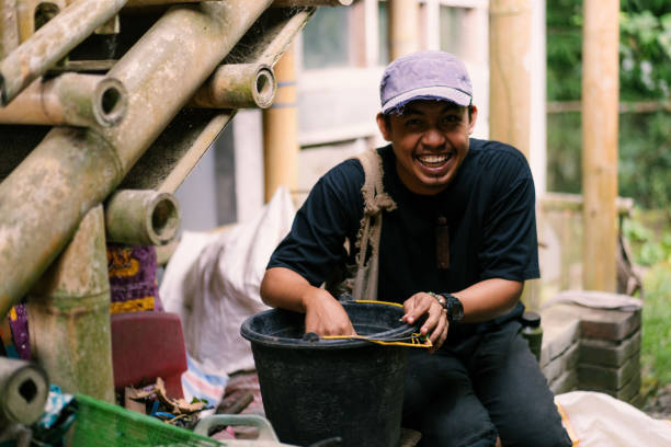 istock Young Man Having Fun Mixing Organic Kitchen Scrap for Chicken Feed 2161082985