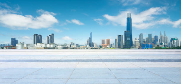 Empty square floor is providing space for product placement with modern city skyline in the background