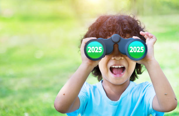 istock Little boy looking through binocular exciting with new year number 2025 2161094855
